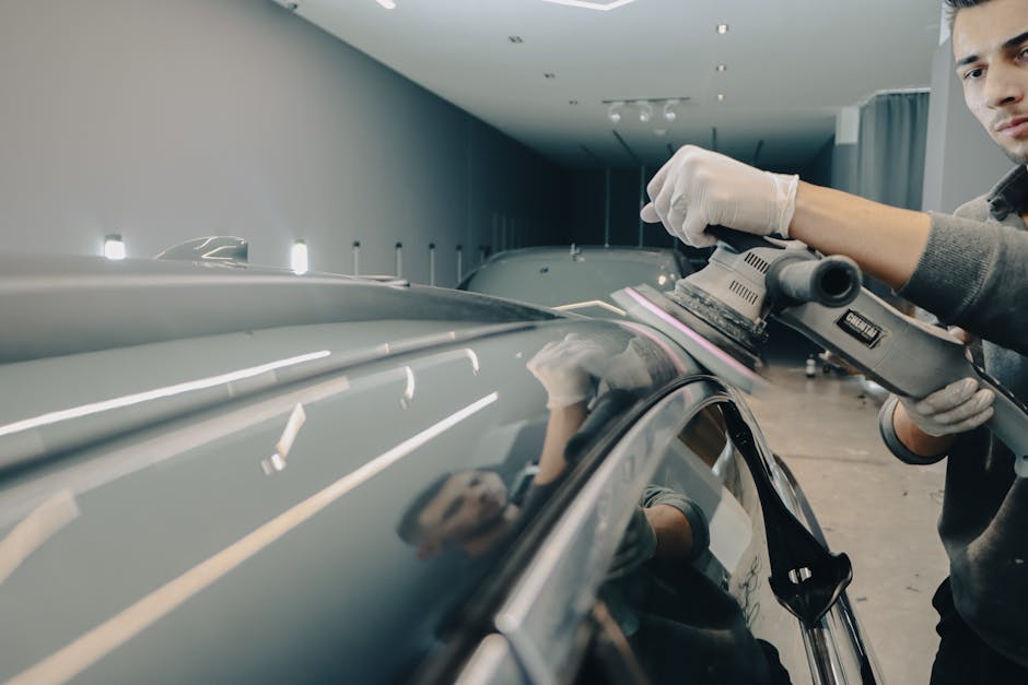 Auto detailing professional inspecting vehicle exterior